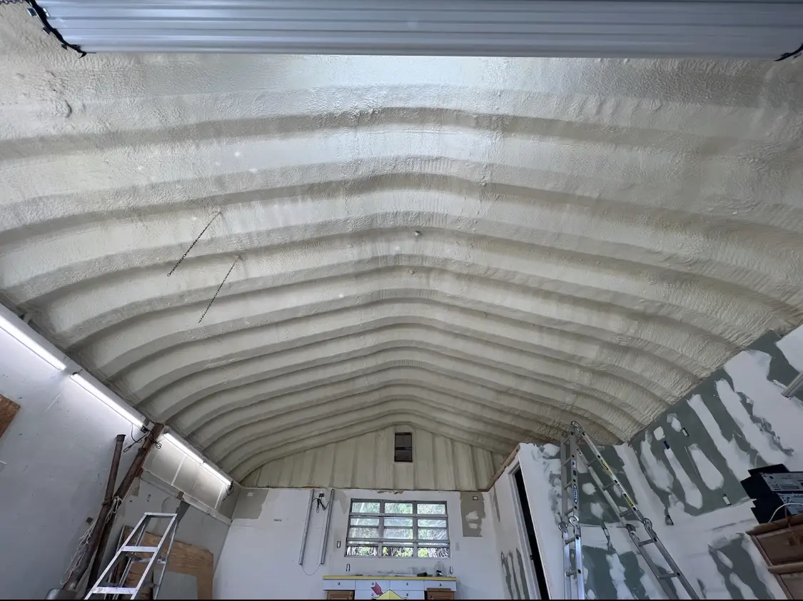Spray polyurethane foam applied to the underside of a metal roof deck in Floris